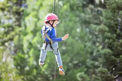 Little boy ziplining