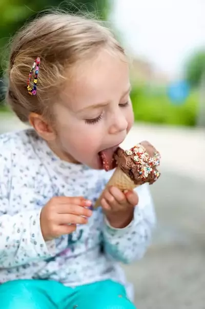 little girl eating ice cream cone