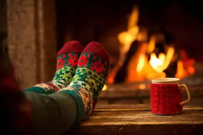 Feet in front of a roaring flame