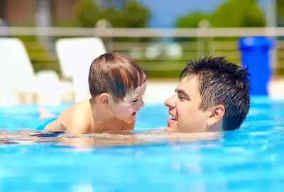 man and son in swimming pool