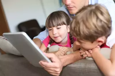 family surfing the internet while staying in a condo in Pigeon Forge Tenn