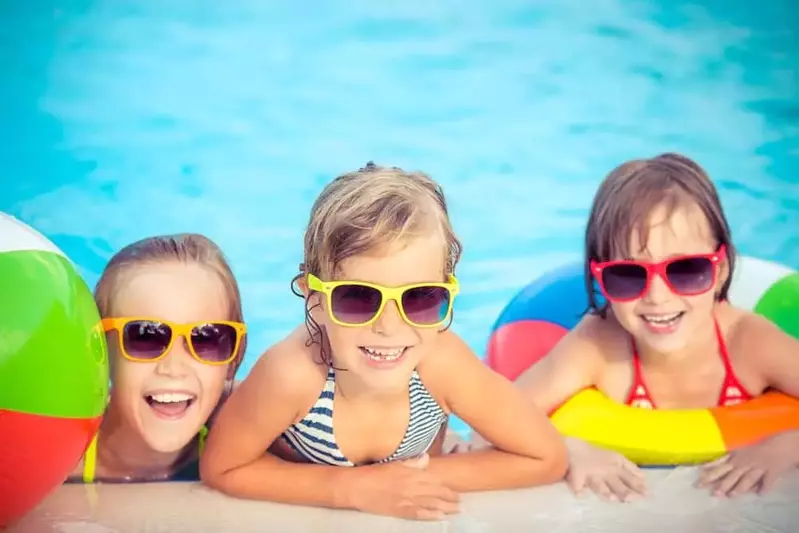 Sisters playing in the pool at our condo rentals in Pigeon Forge with pool access.