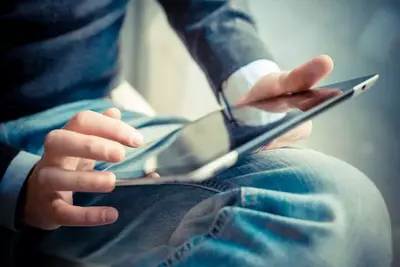 Man using tablet at a Pigeon Forge condo with internet access