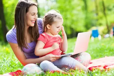 Mother and daughter using laptop outside of their Pigeon Forge condo with internet access