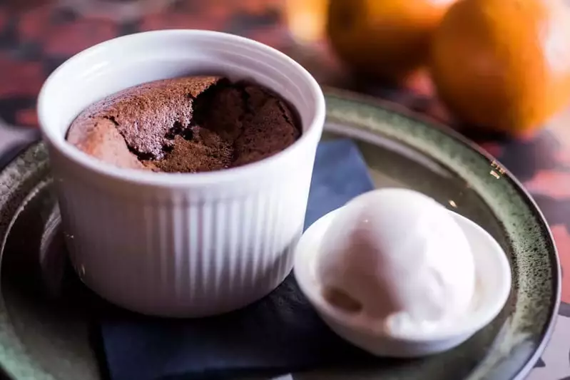 a mug cake on a plate with ice cream