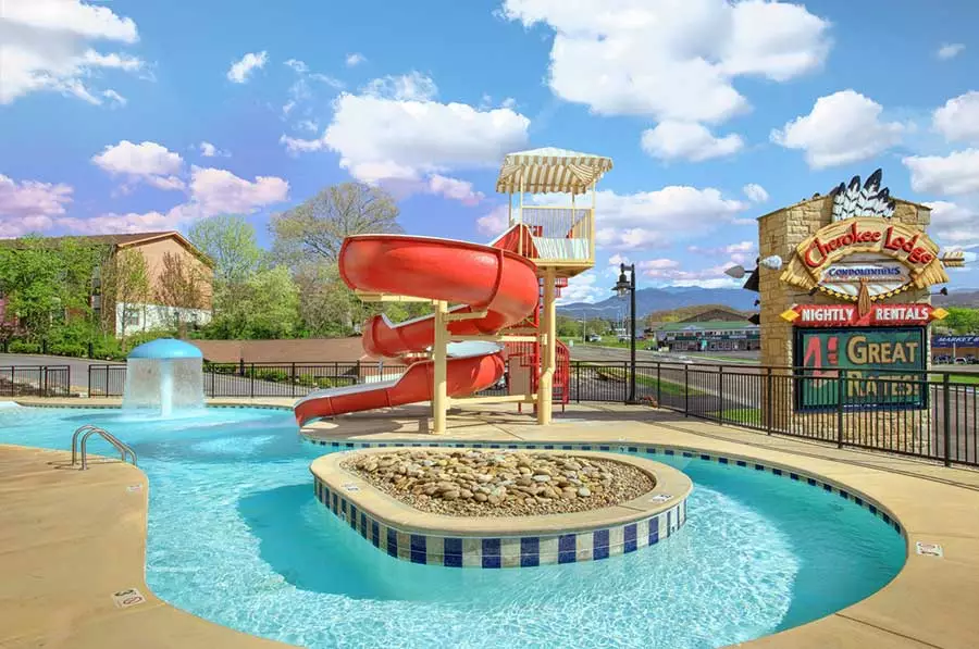 swimming pool with waterslide at Cherokee Lodge